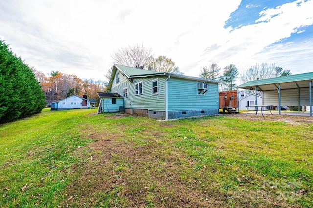 exterior space with a carport, a yard, and a shed