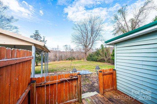 wooden deck featuring a yard