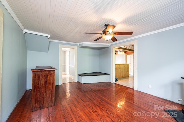 unfurnished living room featuring ornamental molding, dark wood-type flooring, wooden ceiling, and ceiling fan