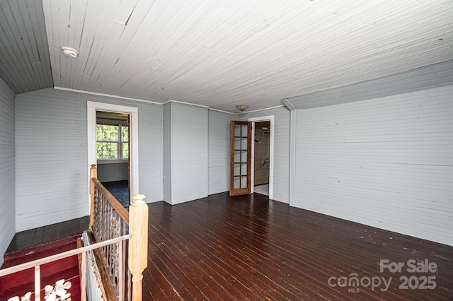 spare room featuring dark hardwood / wood-style flooring, wood ceiling, and lofted ceiling