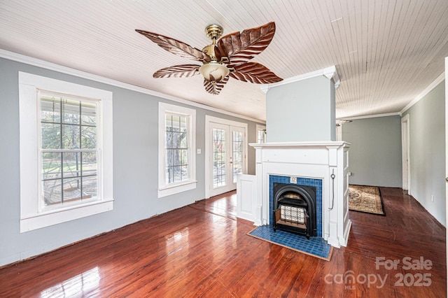 unfurnished living room featuring crown molding, dark hardwood / wood-style floors, and a healthy amount of sunlight