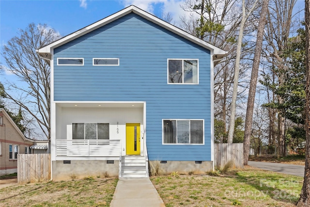 view of front of home with crawl space, fence, a front lawn, and entry steps