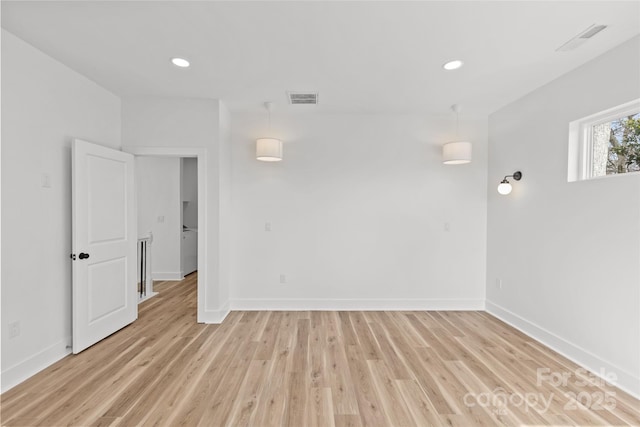 unfurnished room with light wood-style floors, recessed lighting, visible vents, and baseboards