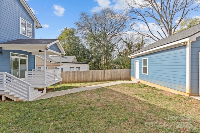 view of yard featuring fence and a deck