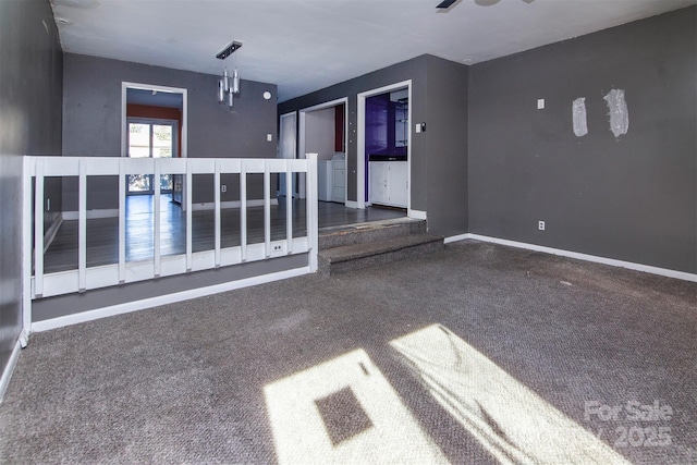 unfurnished room with ceiling fan, independent washer and dryer, and dark carpet