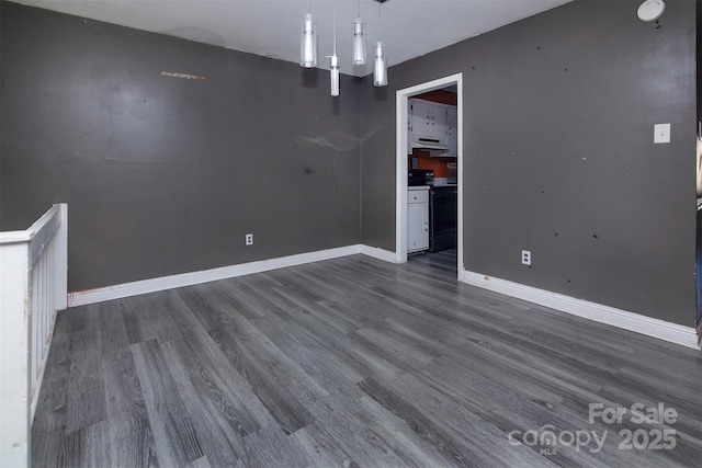 unfurnished dining area featuring dark wood-type flooring