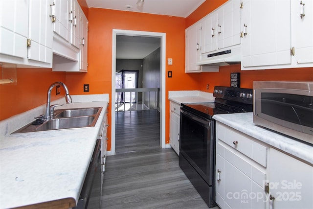 kitchen with sink, dishwasher, white cabinetry, electric range, and dark hardwood / wood-style flooring