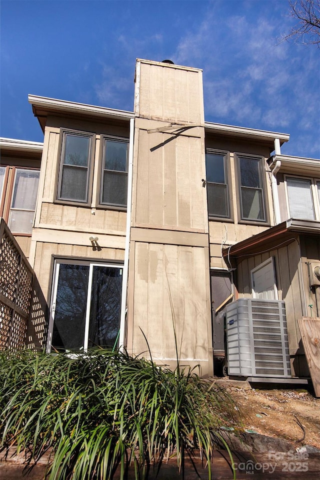 view of side of property with central AC