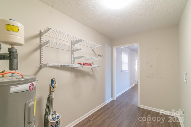 interior space with electric panel and electric water heater