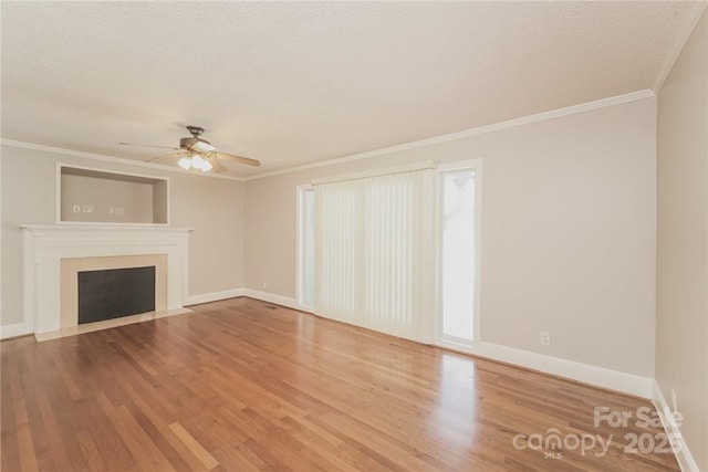 unfurnished living room with ceiling fan, crown molding, wood-type flooring, and a textured ceiling