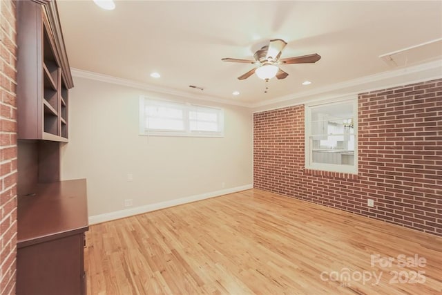 interior space featuring crown molding, ceiling fan, brick wall, and wood-type flooring