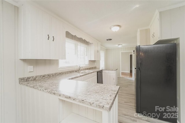 kitchen featuring sink, fridge, white cabinets, stainless steel dishwasher, and kitchen peninsula