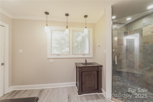 bathroom with hardwood / wood-style flooring, vanity, ornamental molding, and an enclosed shower