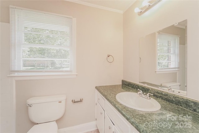 bathroom with crown molding, vanity, and toilet