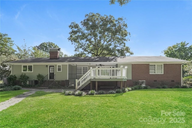 rear view of property featuring a wooden deck, a yard, and central AC unit