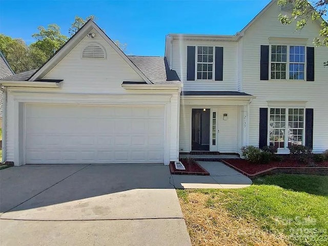 view of front of property with a garage and a front yard