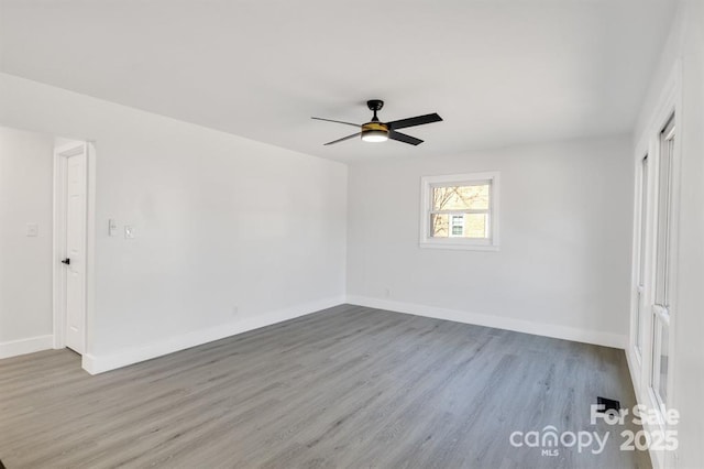 unfurnished room featuring hardwood / wood-style flooring and ceiling fan