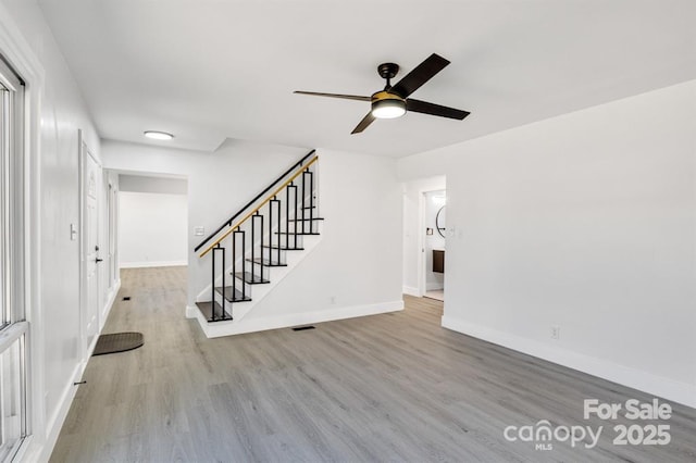 unfurnished living room with ceiling fan and light hardwood / wood-style flooring