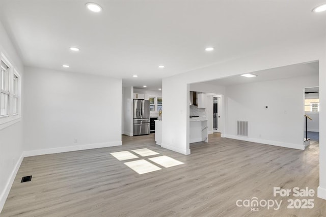 unfurnished living room featuring light hardwood / wood-style flooring