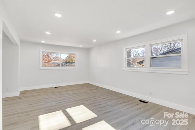 unfurnished room with light hardwood / wood-style floors