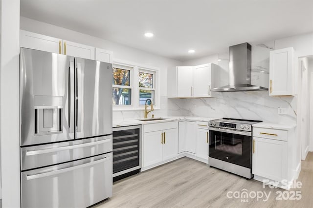 kitchen featuring extractor fan, beverage cooler, white cabinets, and appliances with stainless steel finishes