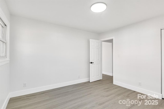 unfurnished room with light wood-type flooring