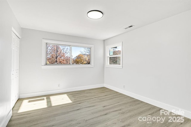 unfurnished room with light hardwood / wood-style floors