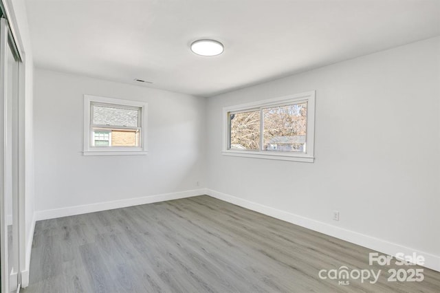 spare room featuring light hardwood / wood-style flooring