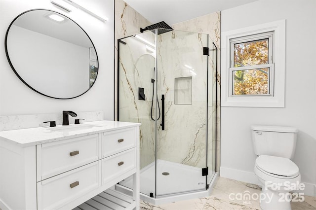 bathroom with vanity, toilet, and walk in shower