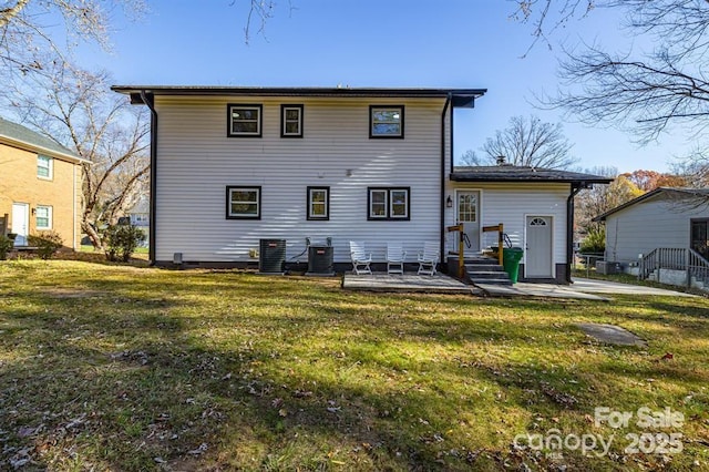 back of house featuring cooling unit, a lawn, and a patio area