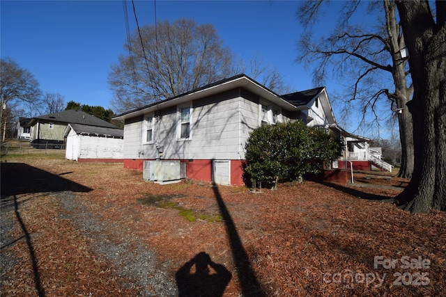 view of home's exterior featuring central air condition unit and a storage unit