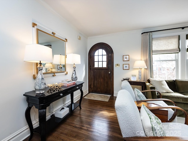 foyer entrance featuring a baseboard heating unit, ornamental molding, and dark hardwood / wood-style floors