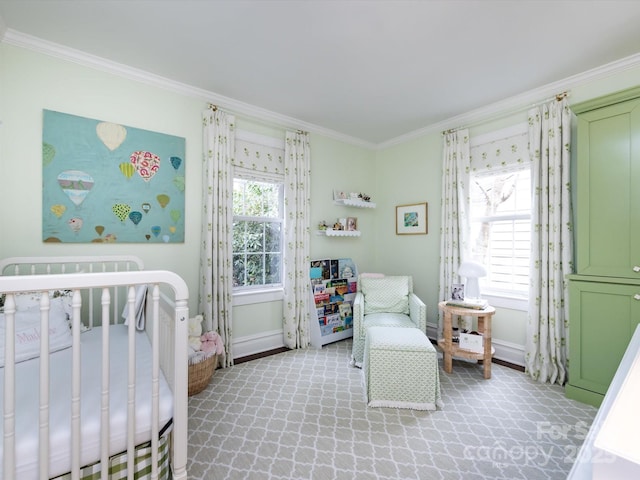 carpeted bedroom featuring multiple windows, ornamental molding, and a nursery area