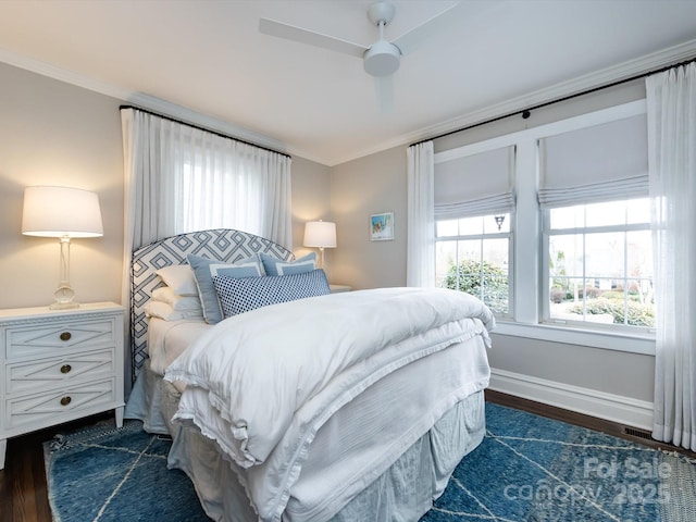 bedroom with crown molding, ceiling fan, and dark wood-type flooring