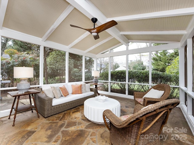 sunroom with ceiling fan and lofted ceiling with beams