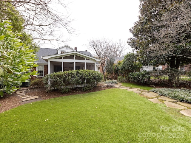 view of yard featuring a sunroom