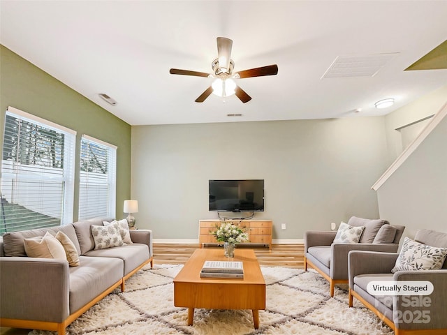 living room featuring light hardwood / wood-style floors and ceiling fan