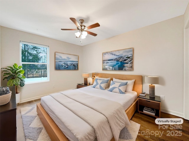 bedroom with hardwood / wood-style floors and ceiling fan