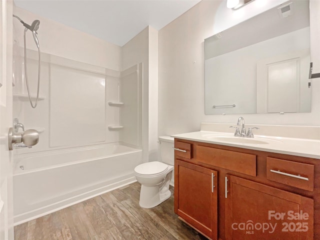 full bathroom with shower / washtub combination, hardwood / wood-style floors, vanity, and toilet