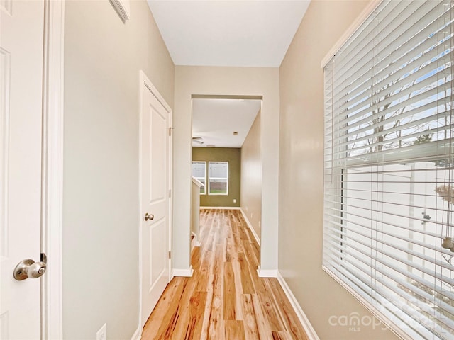 corridor with light hardwood / wood-style floors