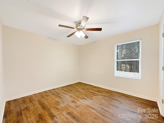 spare room with wood-type flooring and ceiling fan