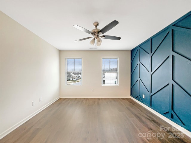 spare room featuring ceiling fan and wood-type flooring