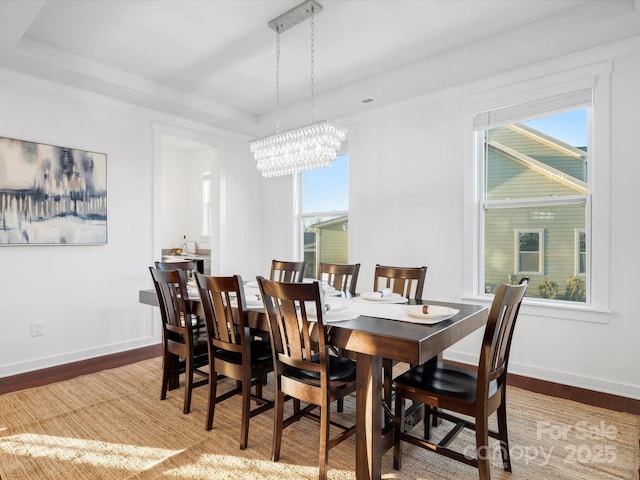 dining area featuring hardwood / wood-style flooring and a chandelier