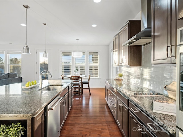 kitchen featuring dishwasher, sink, a kitchen island with sink, black electric cooktop, and wall chimney exhaust hood