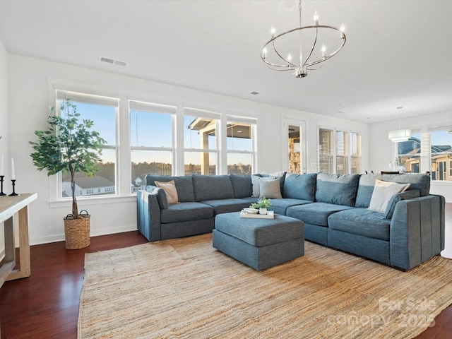 living room with hardwood / wood-style floors and a notable chandelier