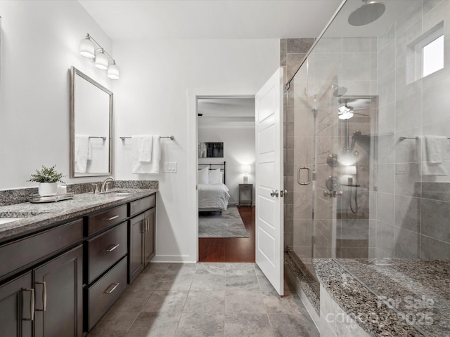 bathroom featuring vanity and a shower with door