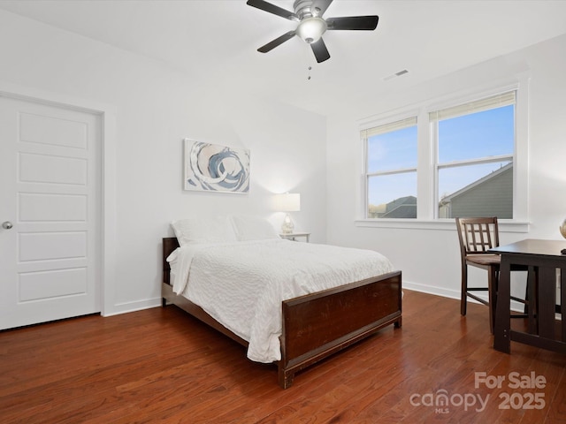 bedroom with dark wood-type flooring