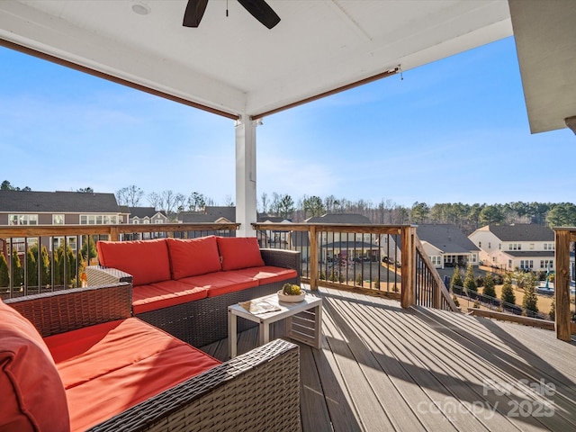 deck with outdoor lounge area and ceiling fan