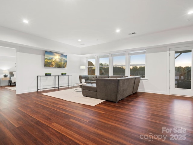 unfurnished living room featuring dark wood-type flooring