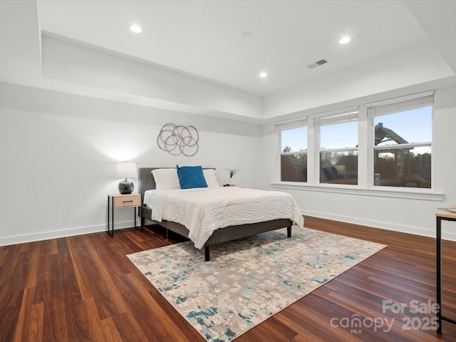 bedroom with dark hardwood / wood-style flooring